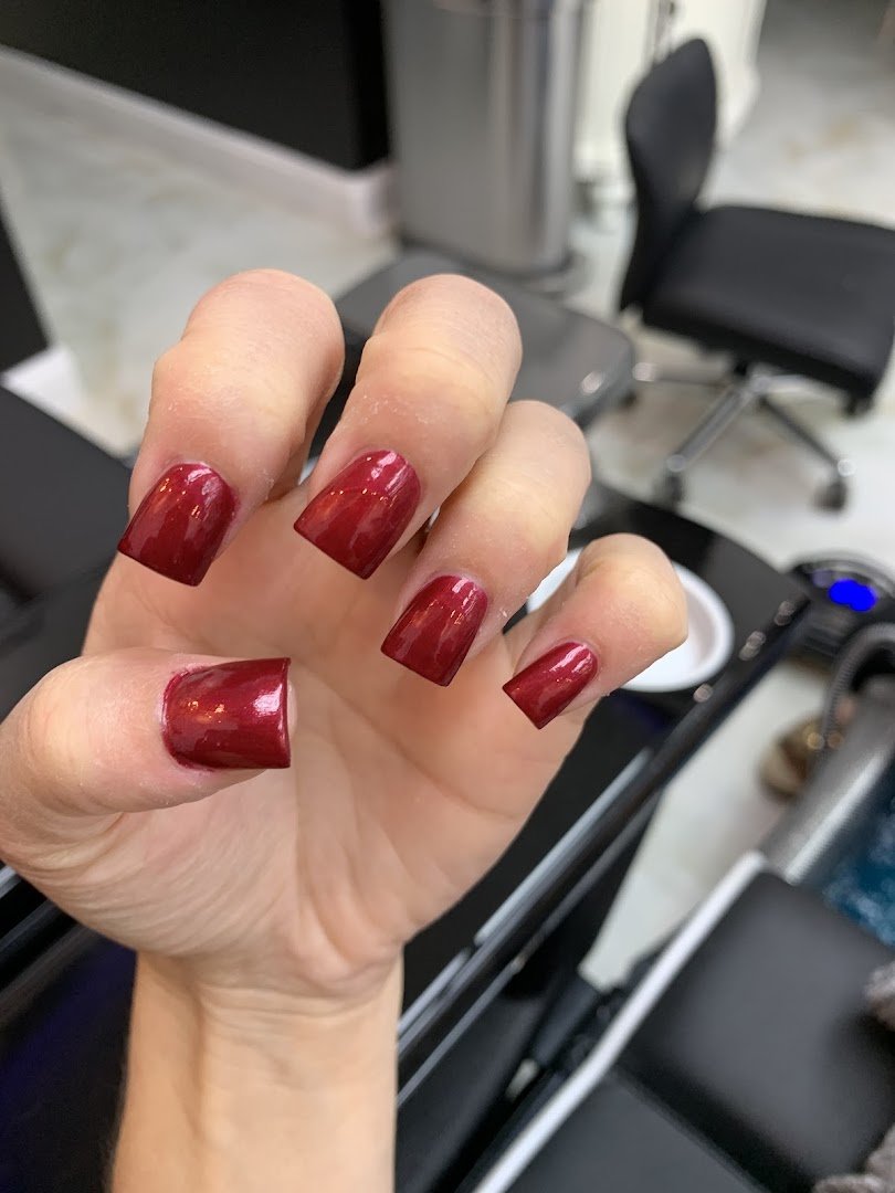 Nail salon workstations with polish bottles.